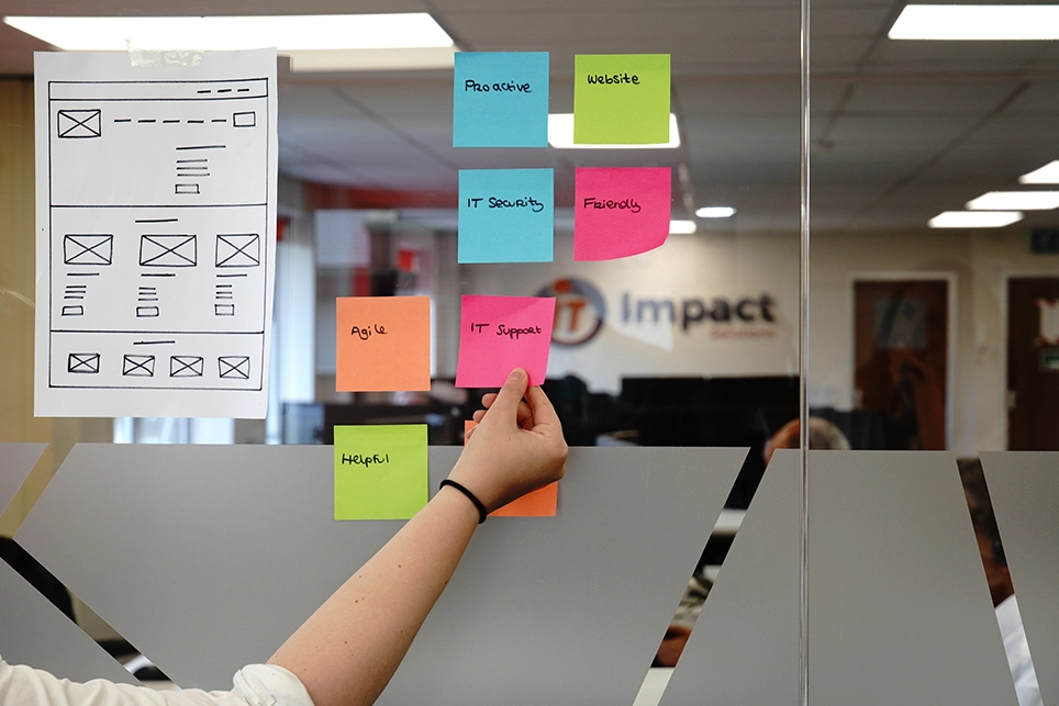 Brainstorming on an app development with post-it notes and a wireframe