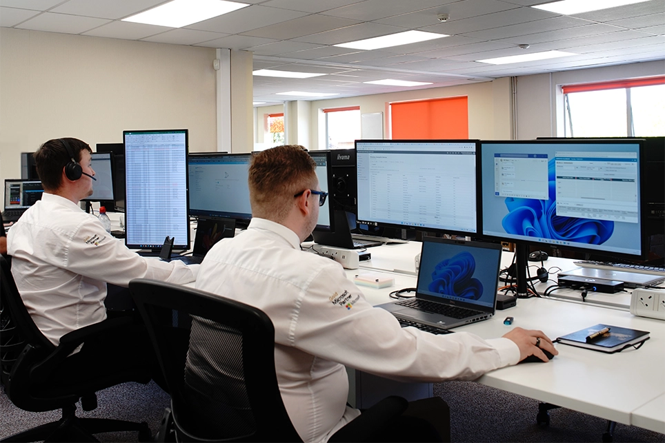 IT support engineers working on computers and on the phone